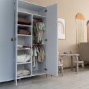 a white closet with clothes in it